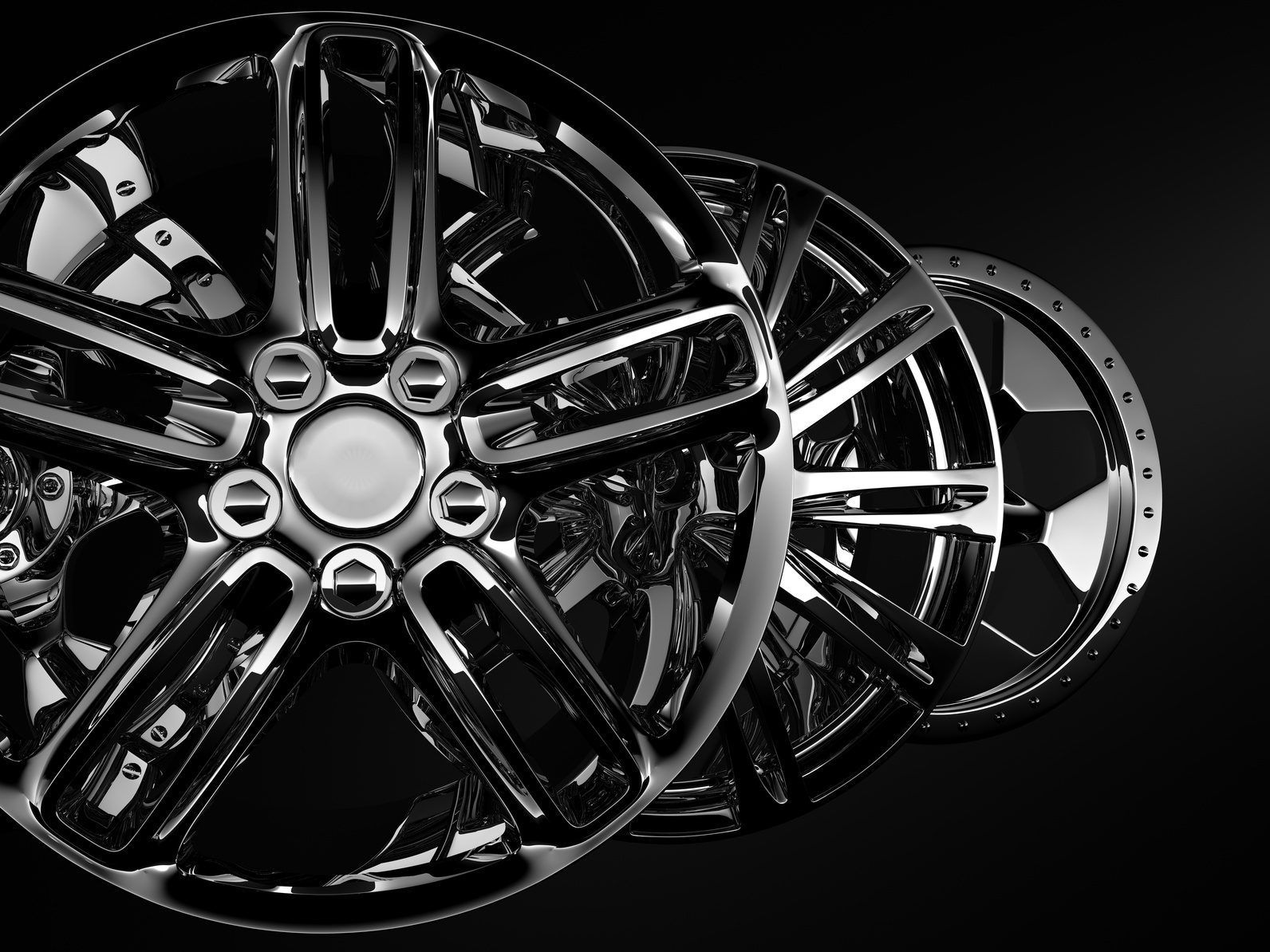 Three shiny alloy wheels